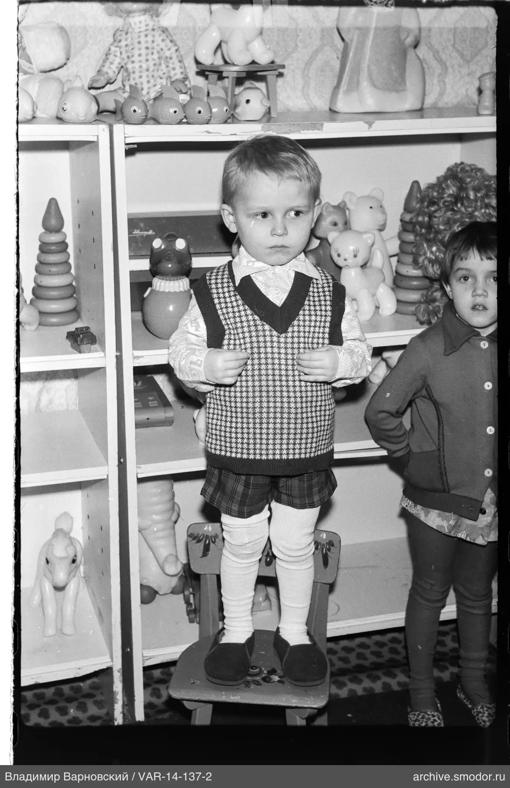 Children with toys and bookshelves