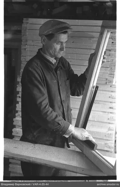 Man with wooden frame and bar