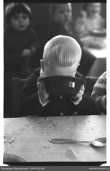 Boy with bowl at table