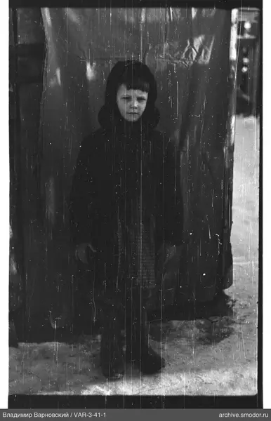 Full-length portrait of a child in dark clothing