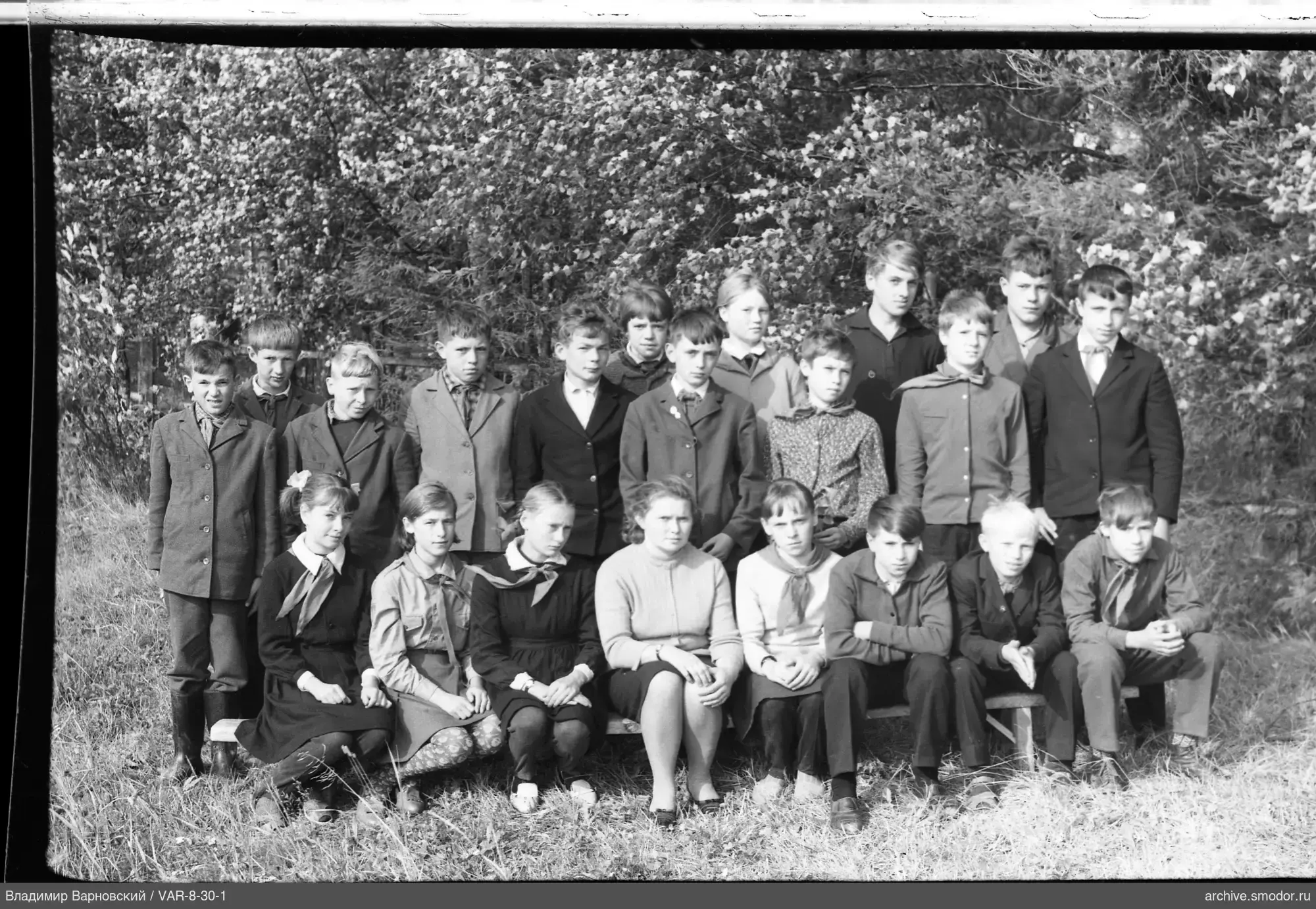 Gruppe von Kindern und Frau auf einer Bank