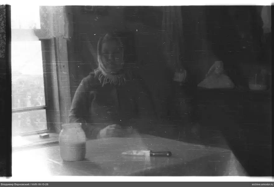 Woman in headscarf at table