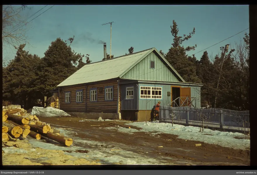 Wooden house with porch and person