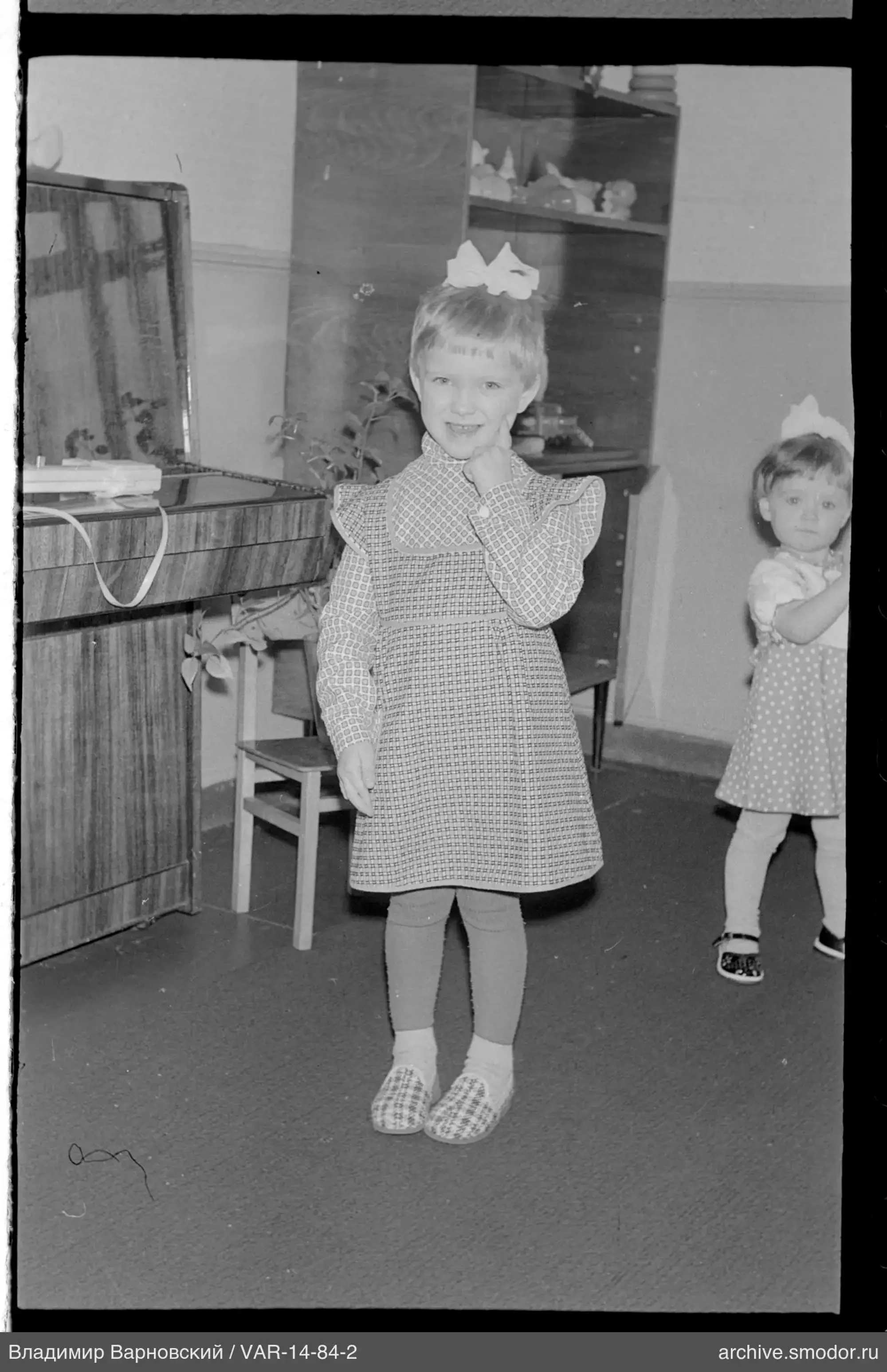Portrait of two girls in dresses with bows