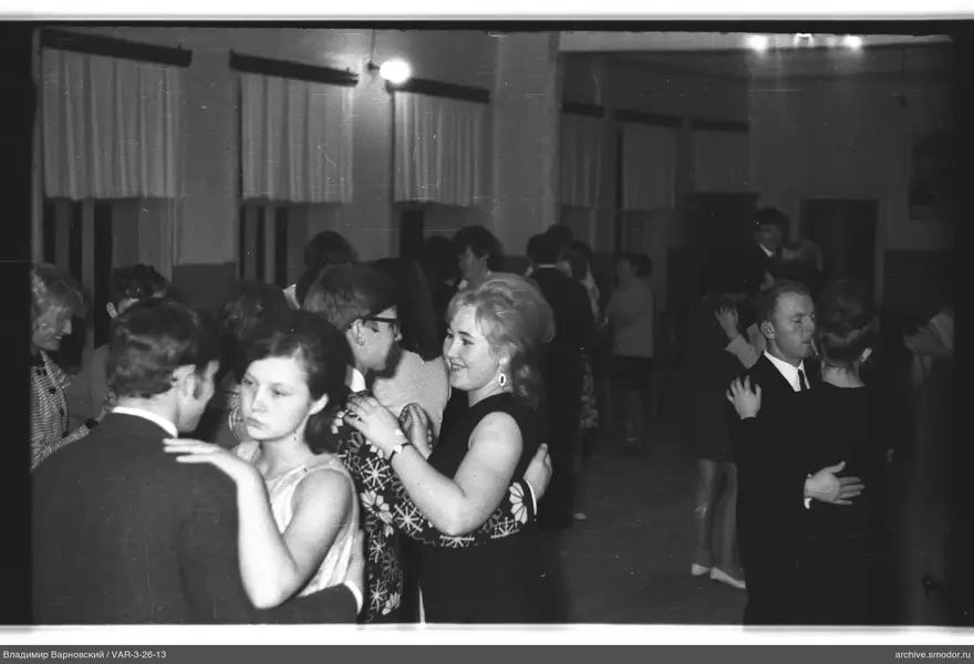 Couple dancing in a hall with tall windows