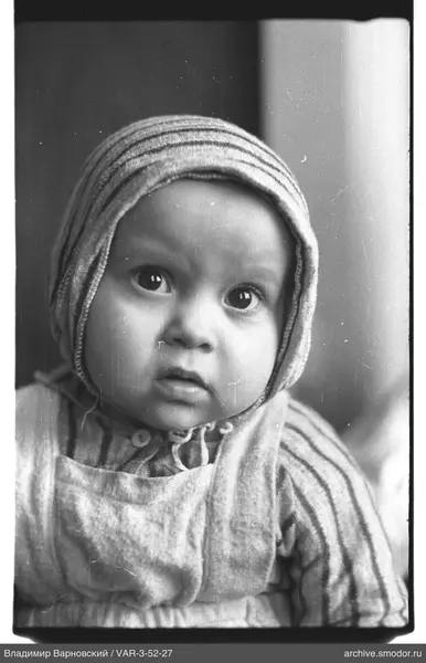 Child portrait with striped headpiece