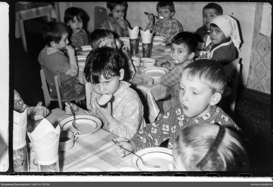 Children sitting at a table eating