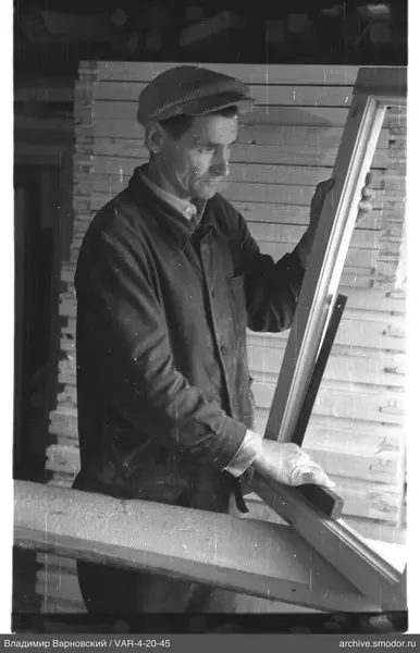 Man with a wooden frame at the table