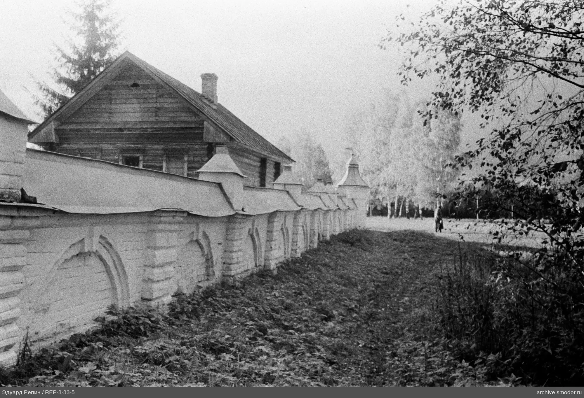 Holzhaus und Ziegelmauer