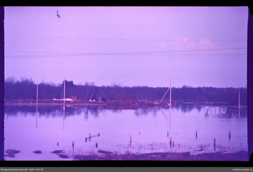 Flooded field with wooden posts and wire