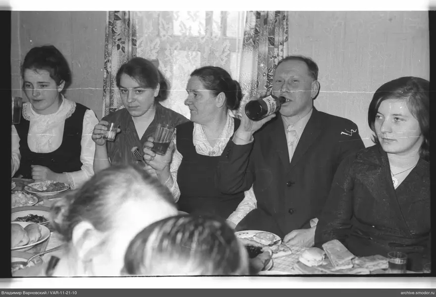 Group sitting at a table with food and drinks