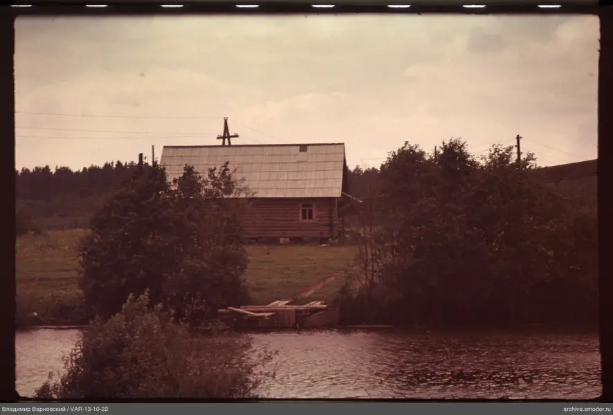 Water body with pier and wooden house