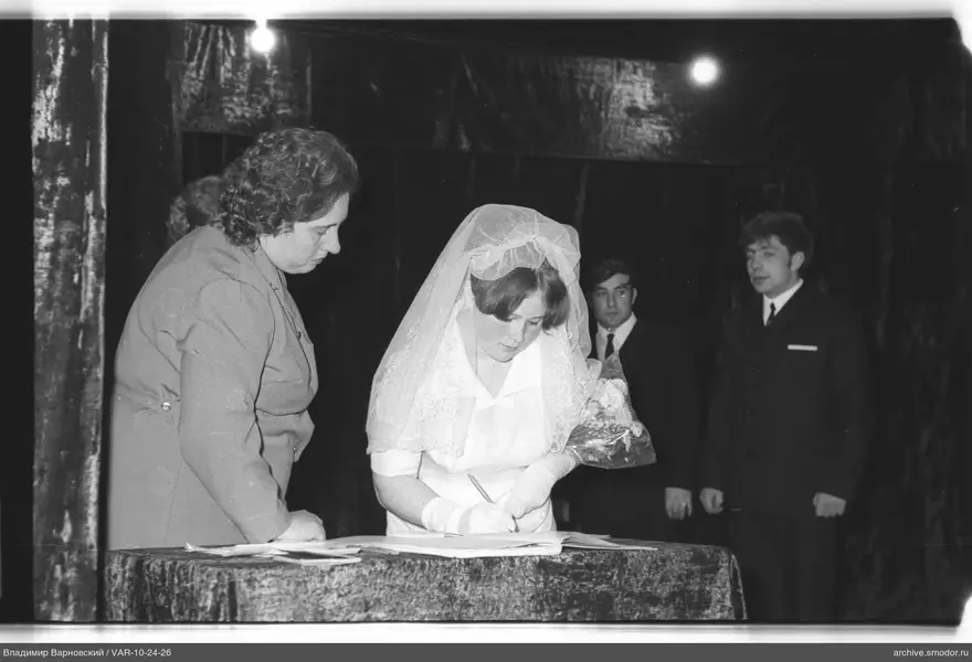 Woman signing a document at an event