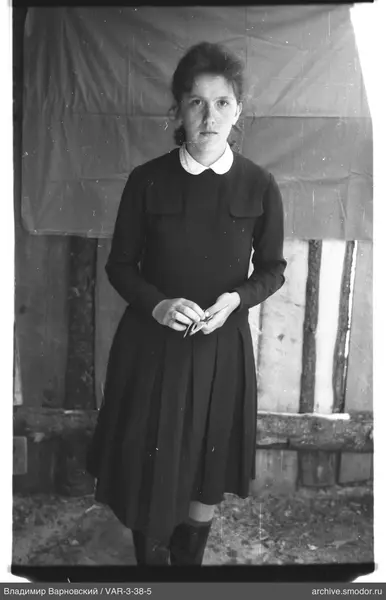 Full-length portrait of a woman in dark dress and boots