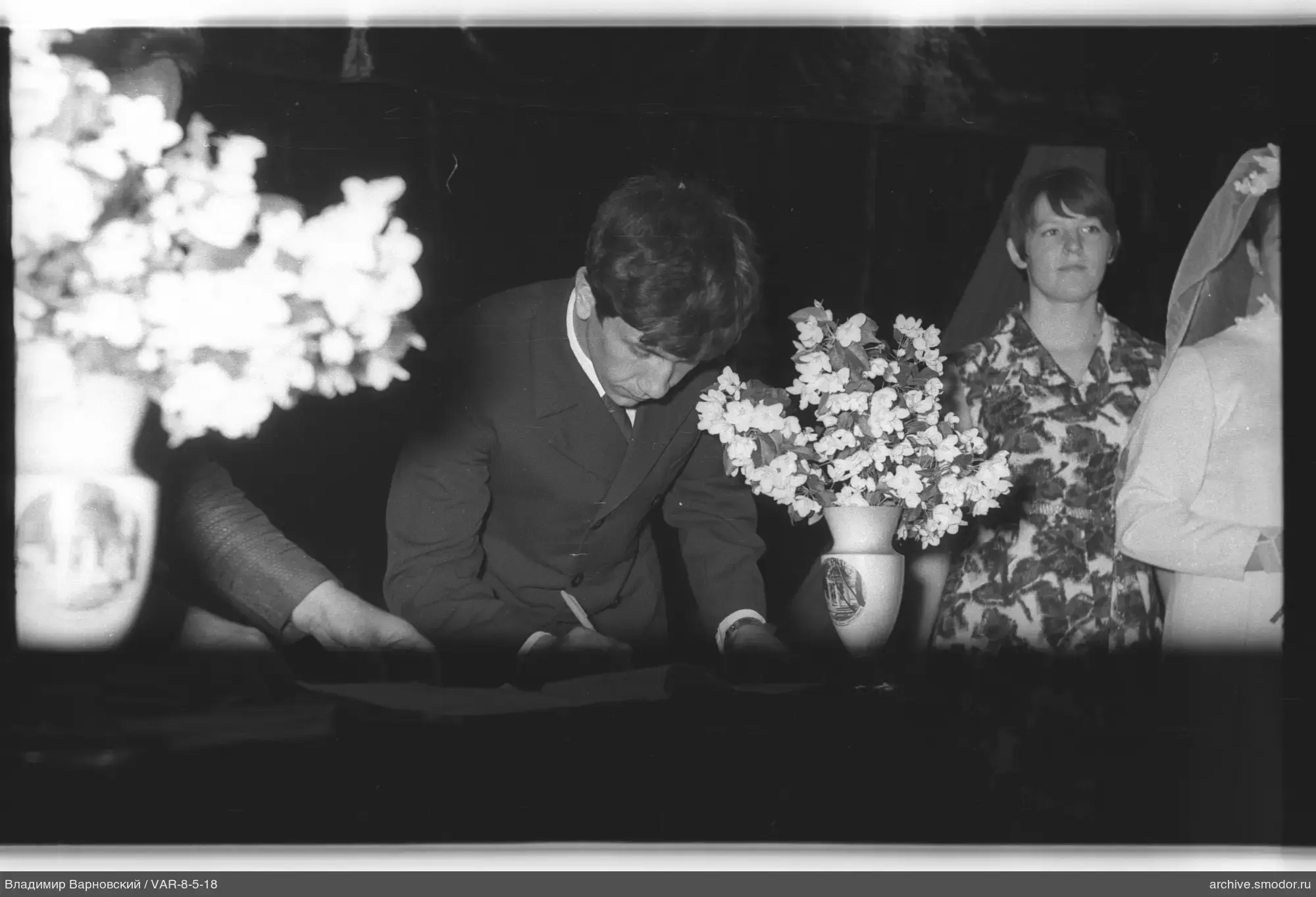 Man writing in a book at the table