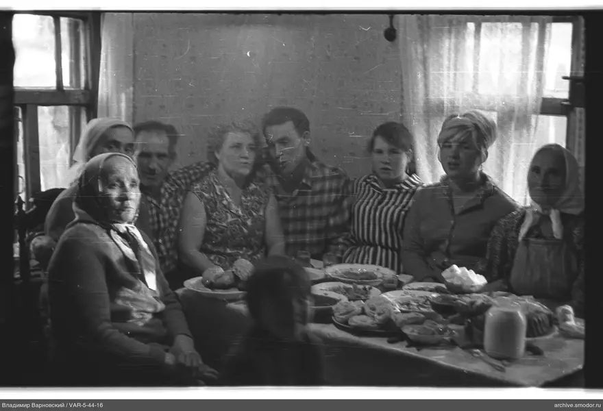 Group sitting at a table with food and drinks