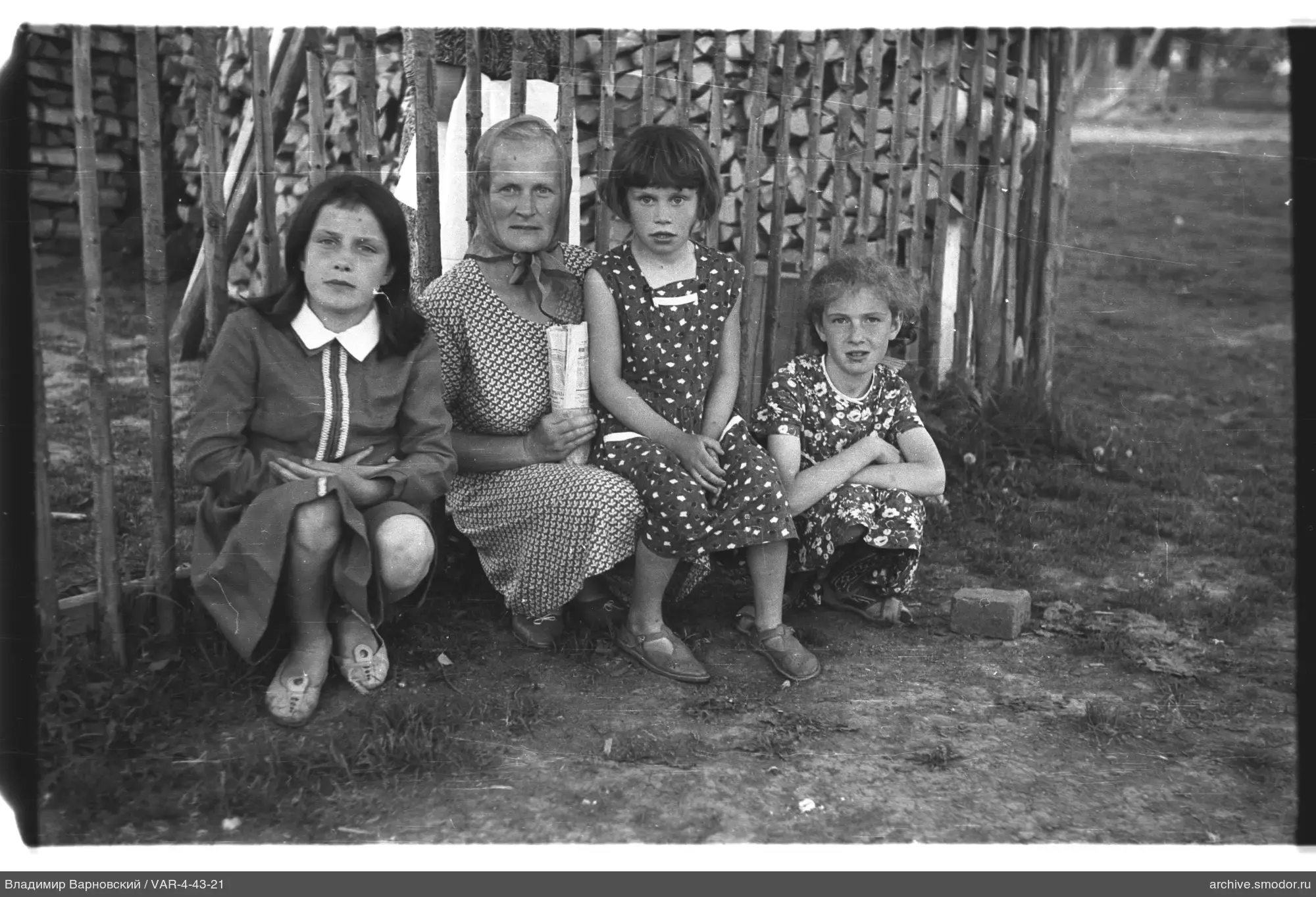 Group of women and girls by a fence