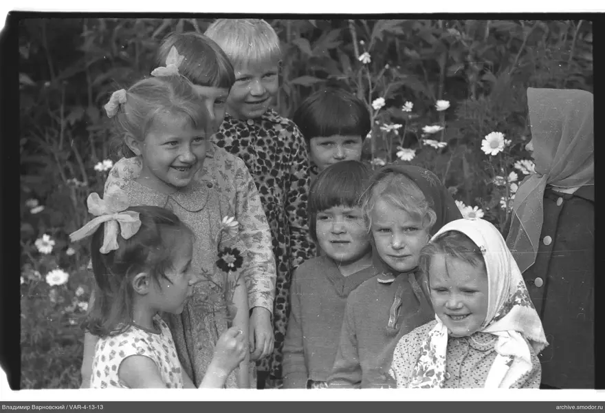 Gruppenporträt von Kindern vor blühenden Pflanzen