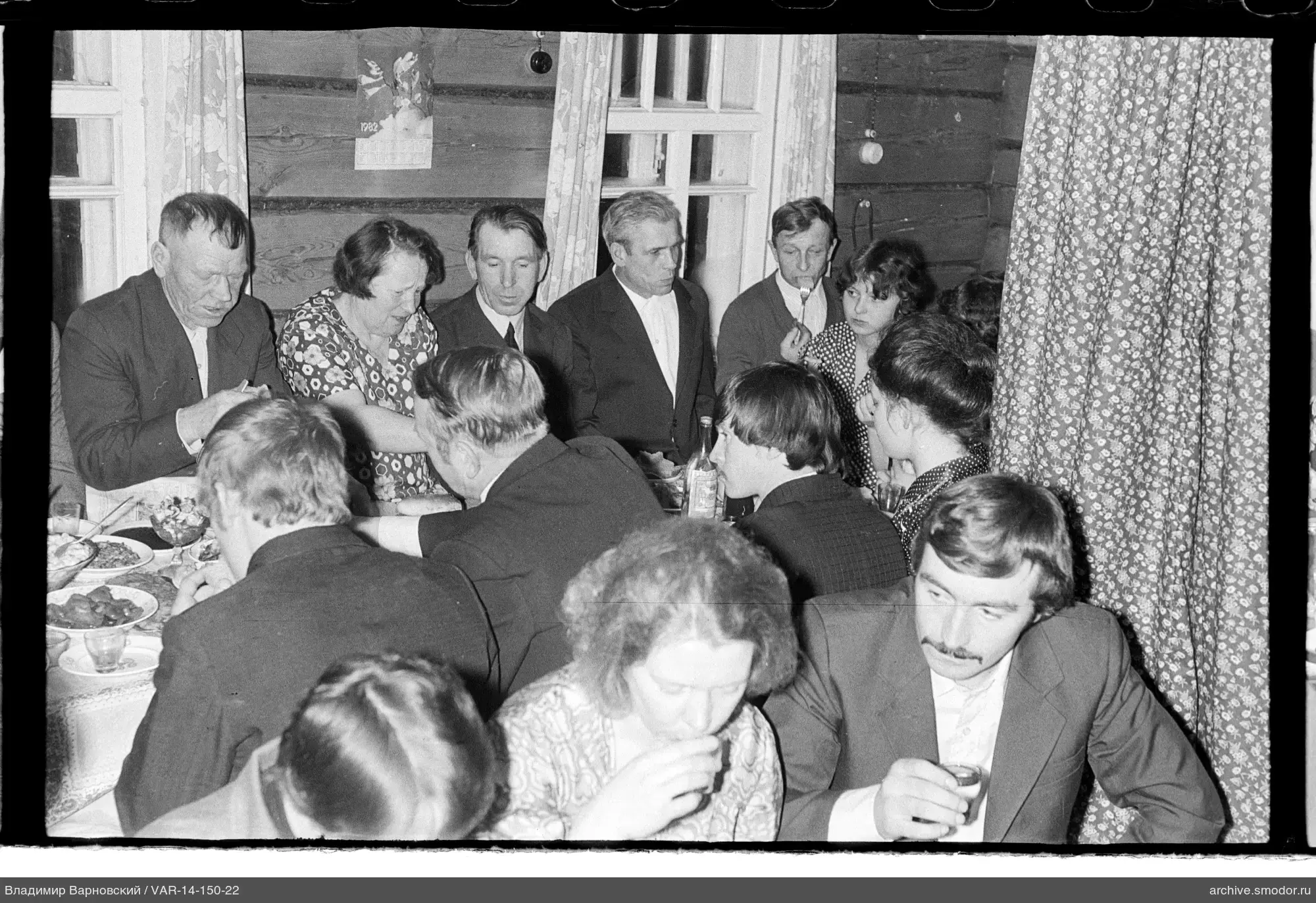 Gruppe am Tisch in einem Holzraum