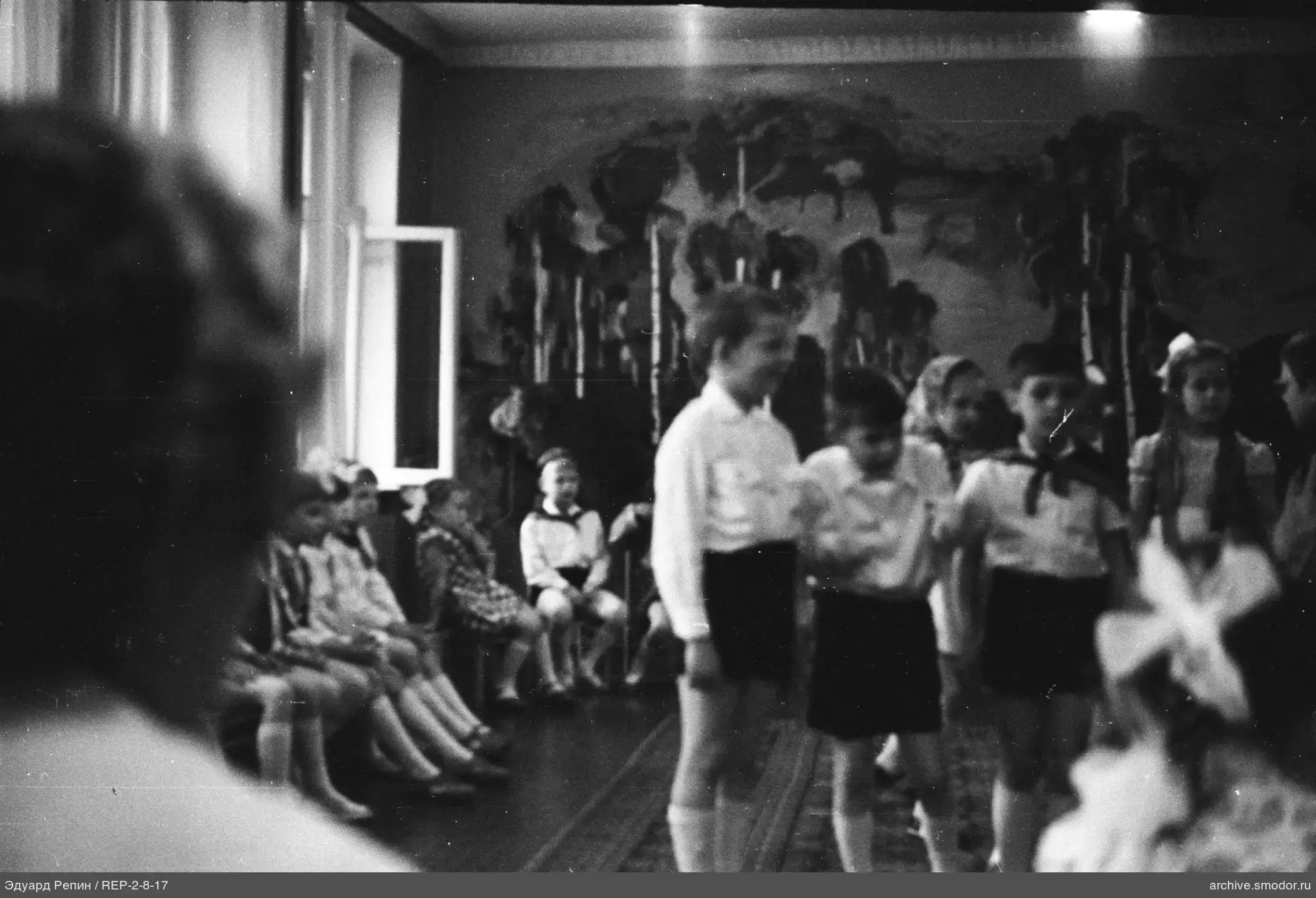 Children in school uniforms and a room scene