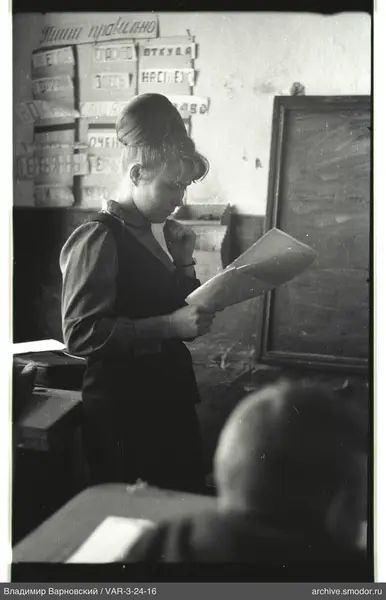 Woman reading a sheet of paper in profile
