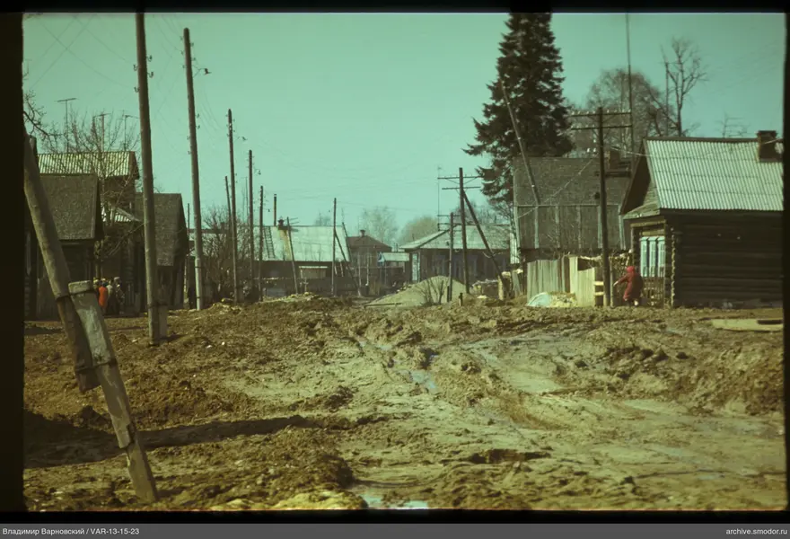 Dirt road with woman in red coat