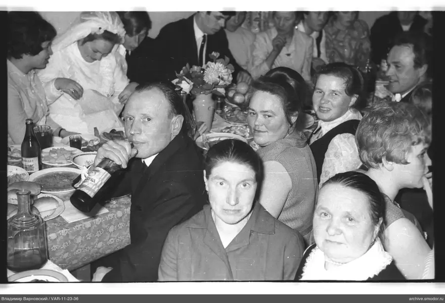 Group of people at a table with food and drinks