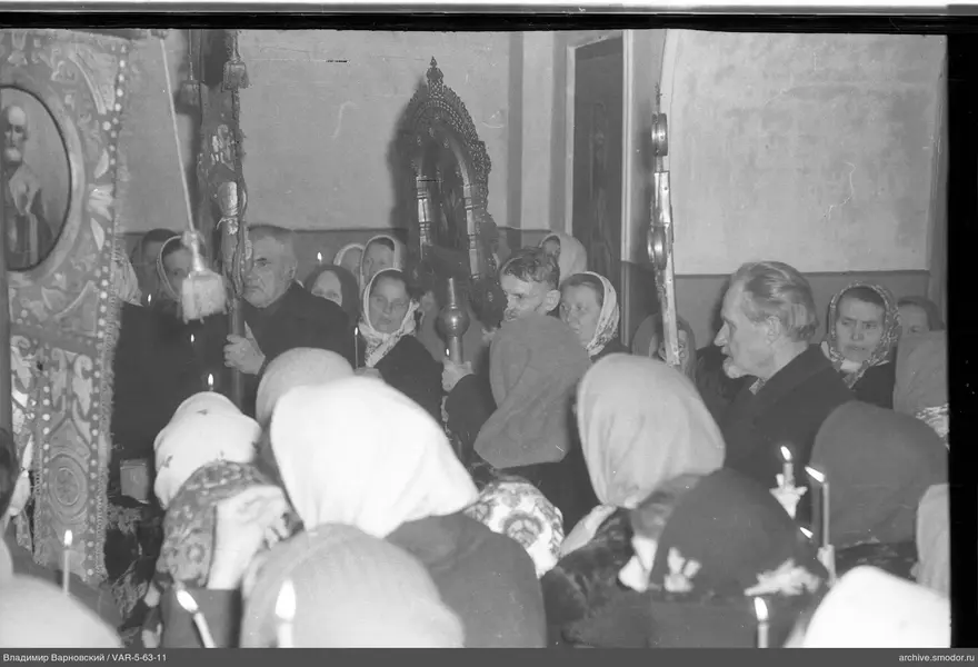 Religiöse Versammlung mit Kerzen und Ikonen