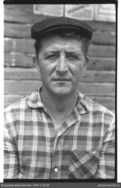 Portrait of a man in a cap and checkered shirt