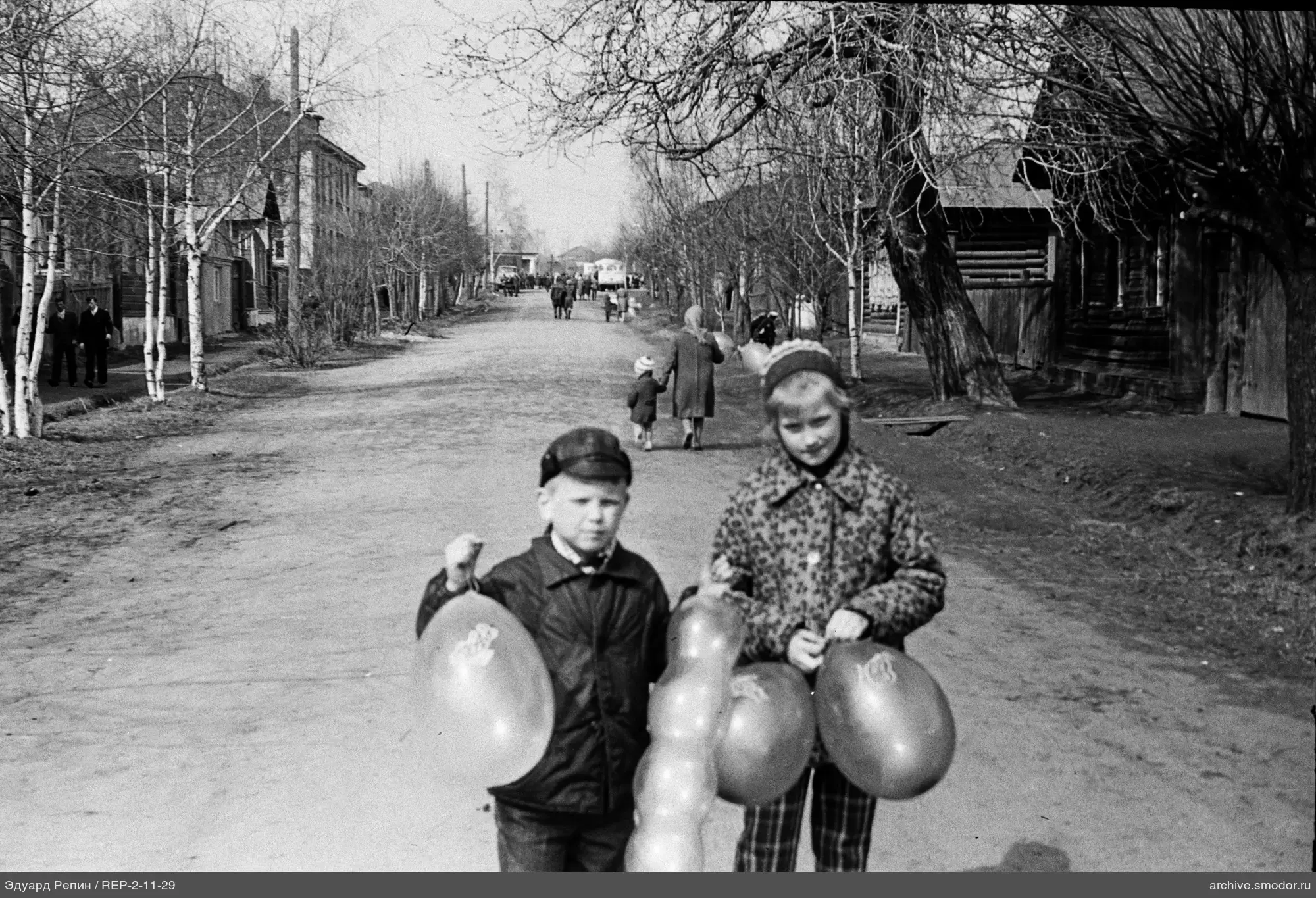 Children with balloons on the street