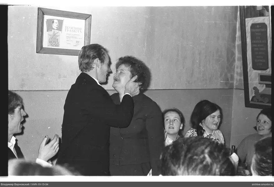 Man holding woman's face at an event