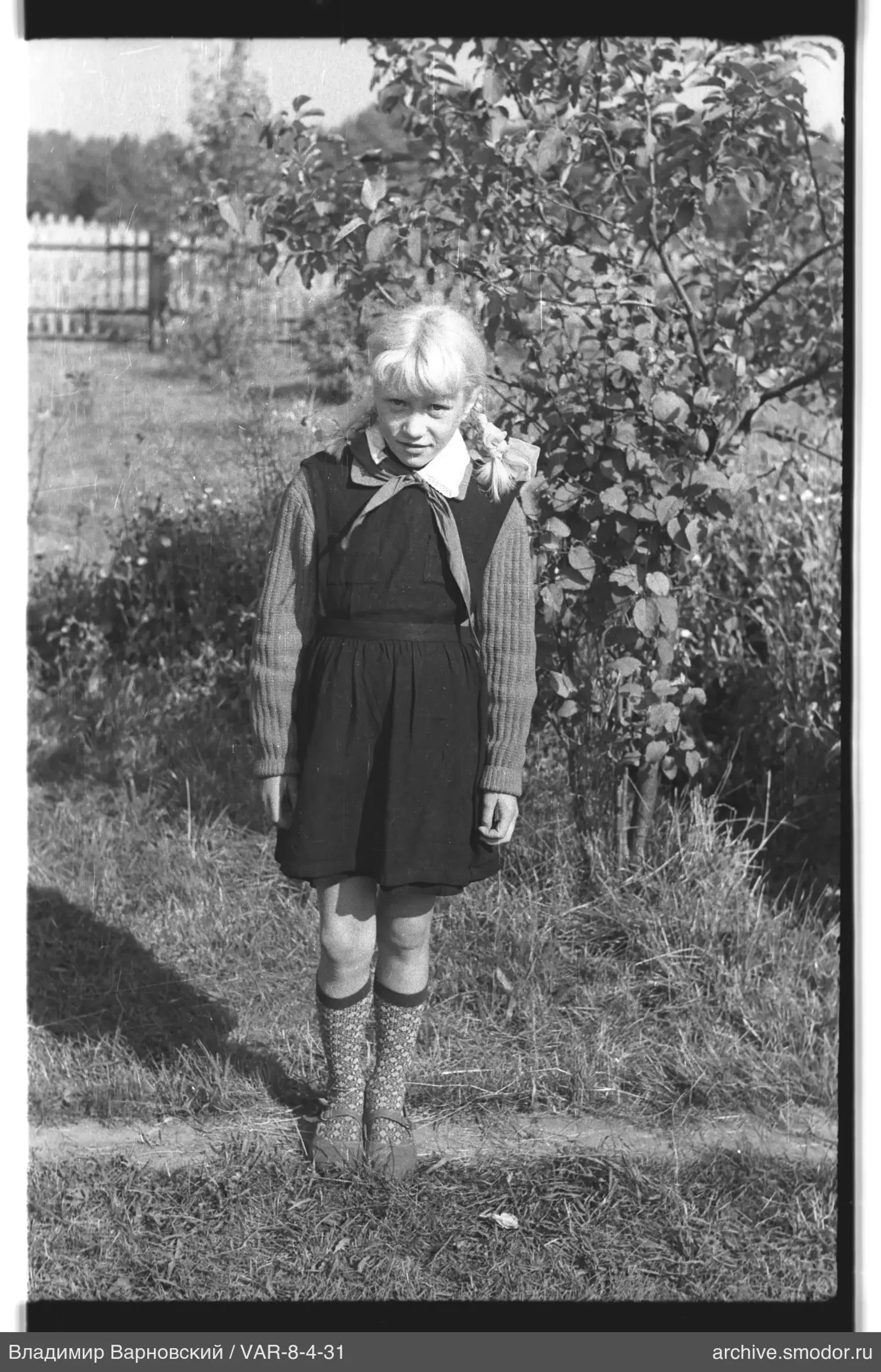 Girl standing on grass with pioneer tie