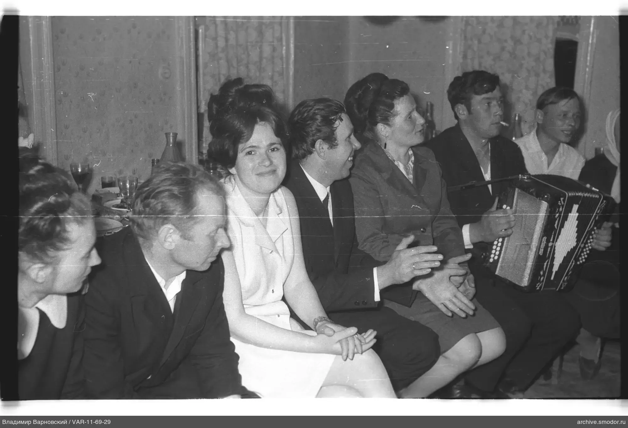 Group of people sitting on a bench indoors