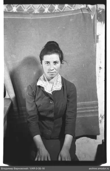 Portrait of a woman with a lace collar and bun