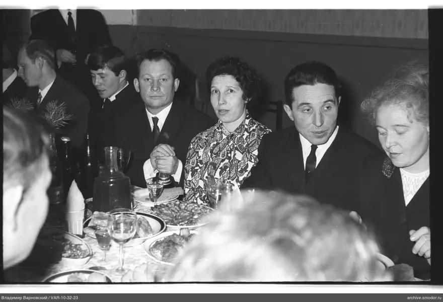 Group sitting at a table with food and drinks