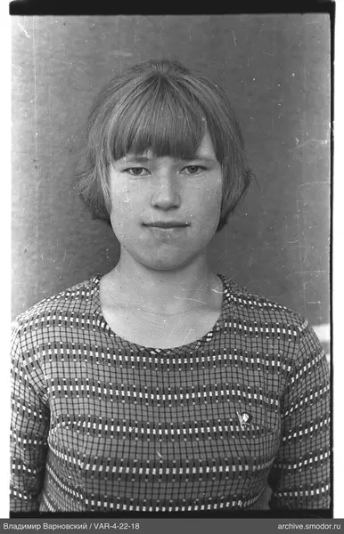 Portrait of a woman with badge and patterned dress
