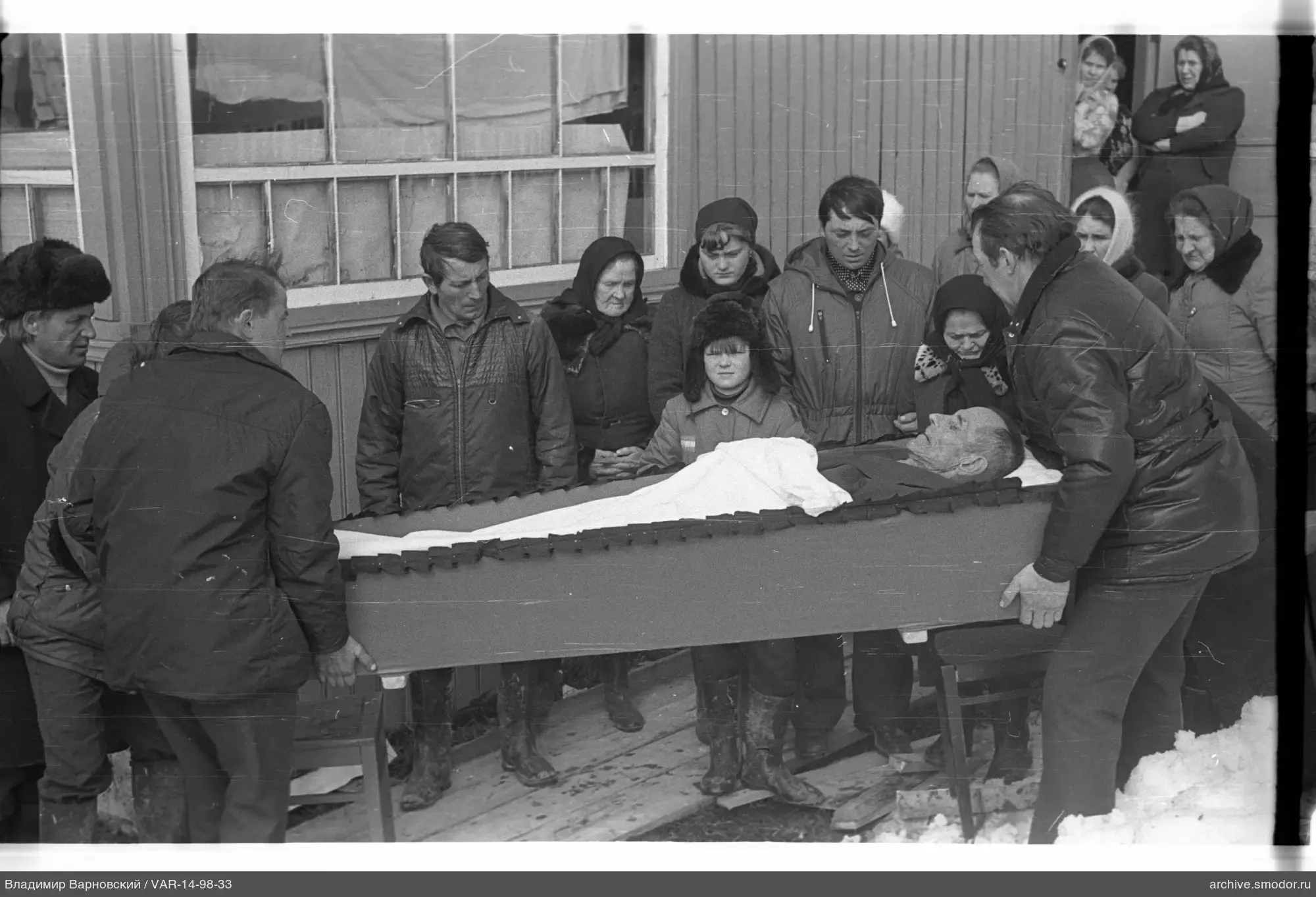 Men carrying a coffin at a funeral