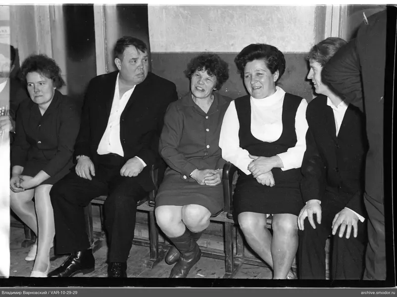 Group portrait on a bench by the wall