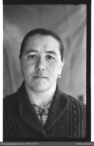 Portrait of a woman in a cardigan and checkered shirt
