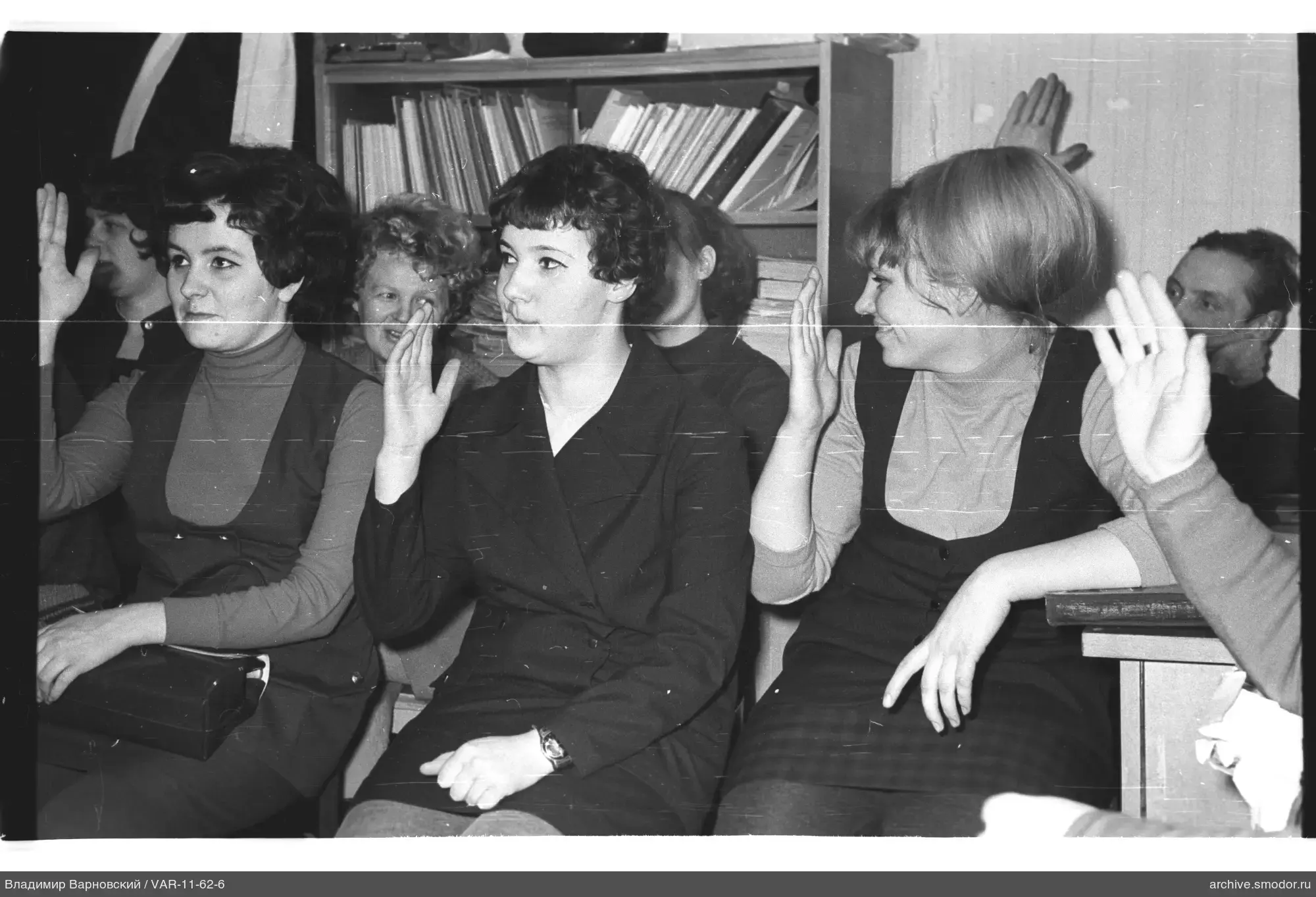Group portrait with raised hands