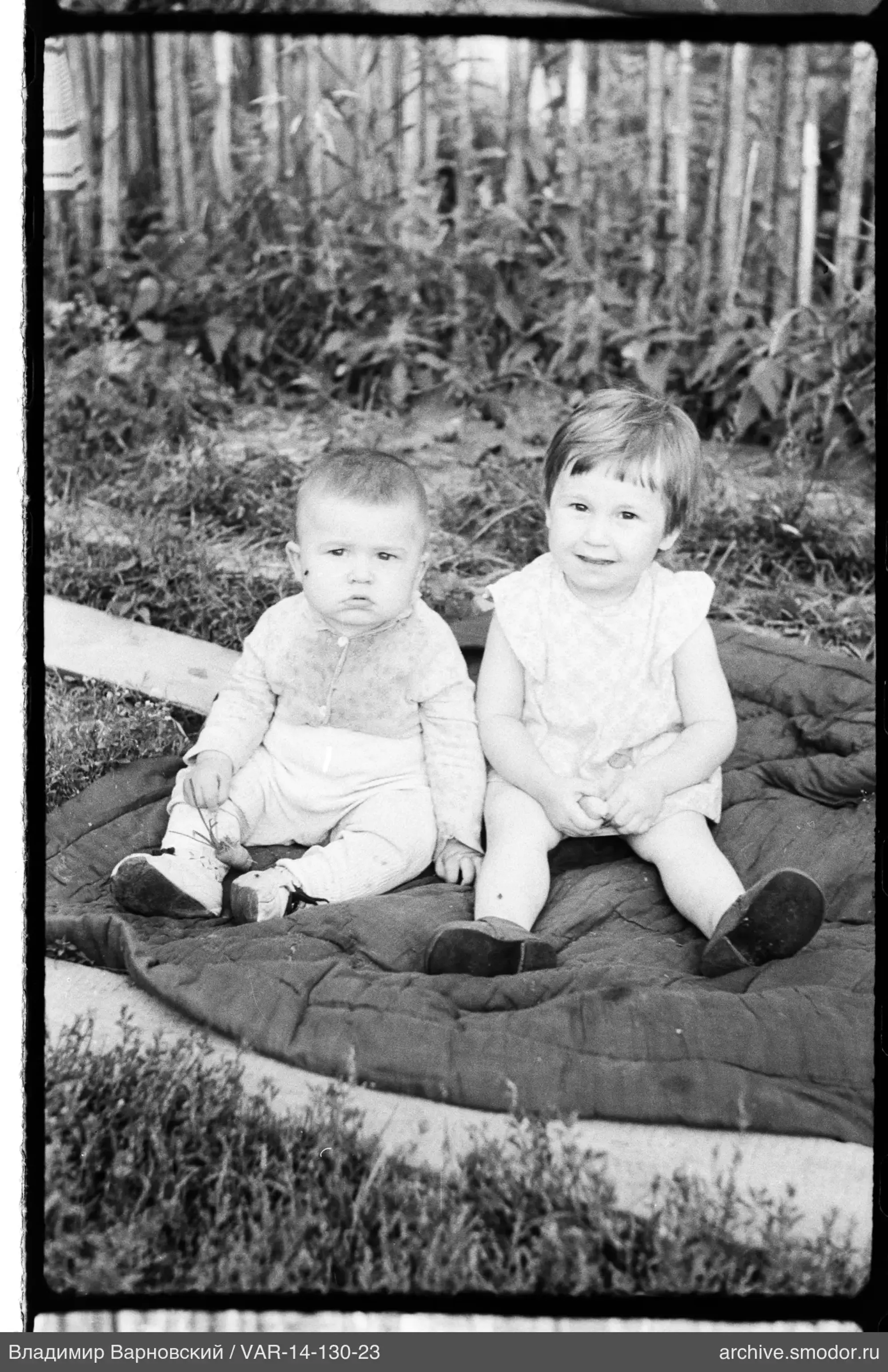 Two children on a blanket