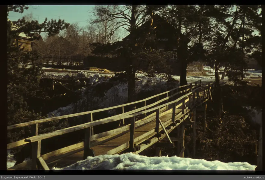 Wooden pedestrian bridge with snow