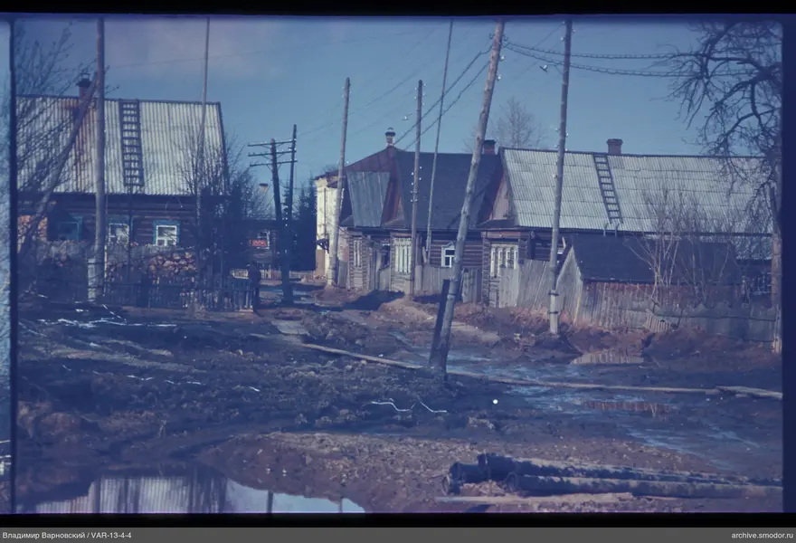 Dirt road with wooden houses and pipes