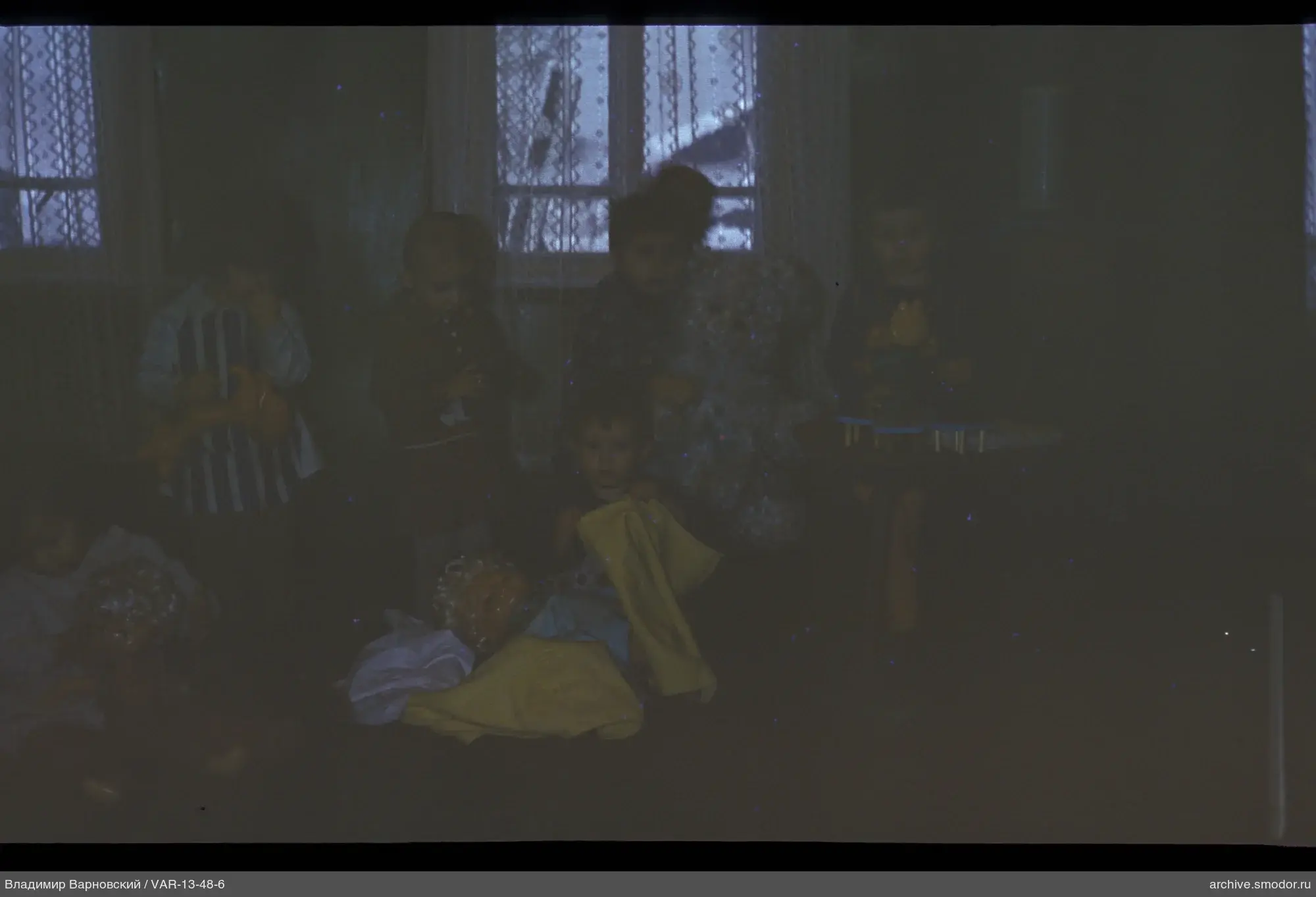 Children with toys by the window