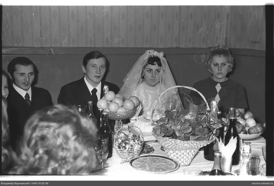 Group sitting at a table with food and drinks