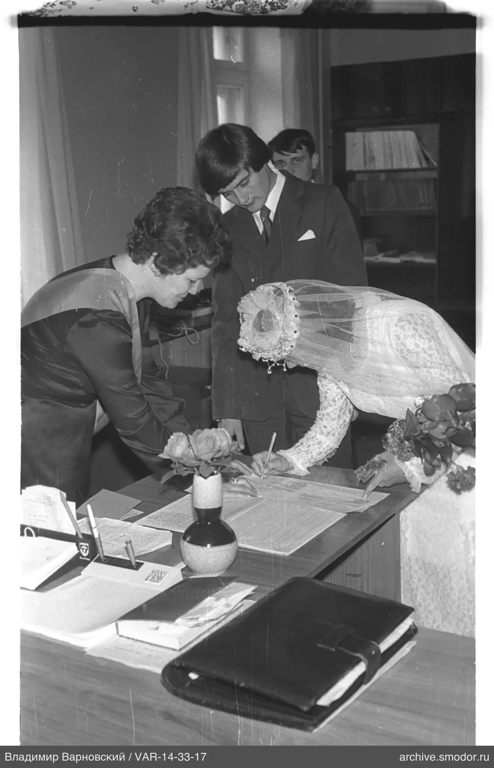 Woman in wedding dress signing a document