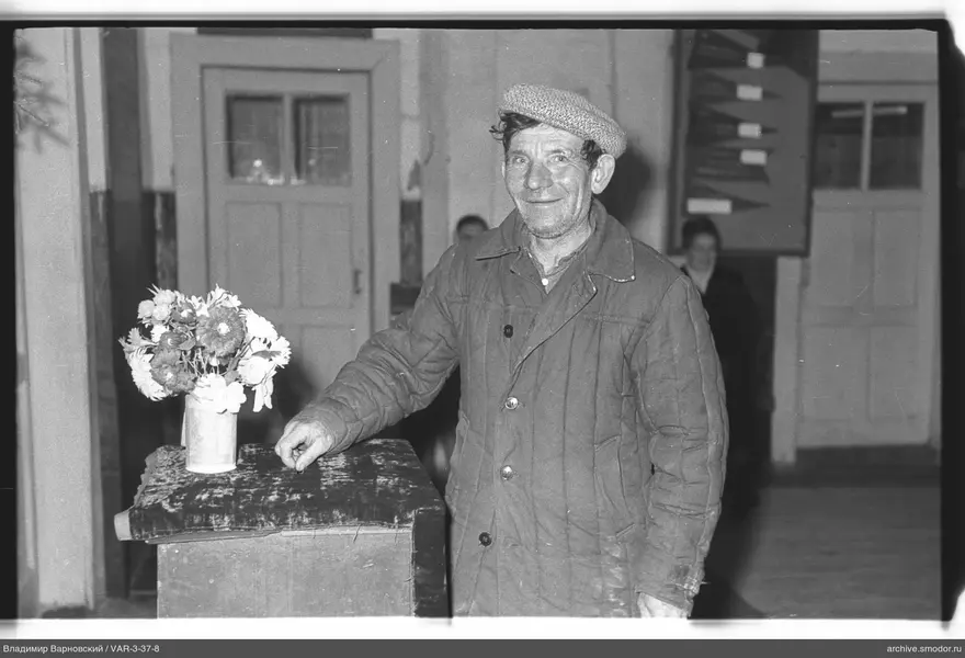 Man at a table with a bouquet of flowers