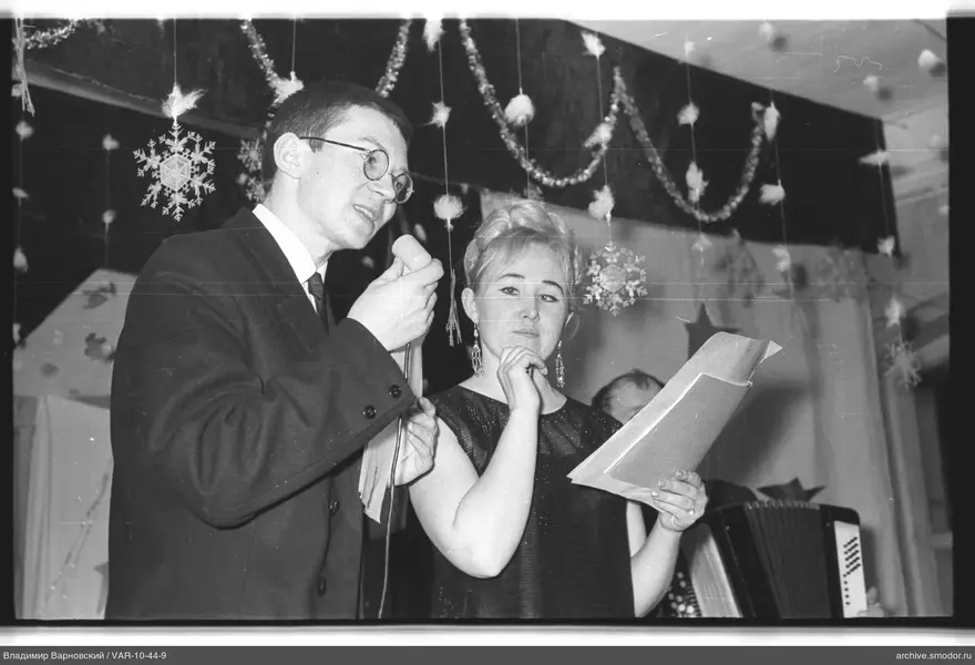 People at an event with microphone and papers