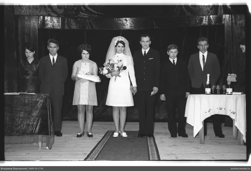Group portrait with woman in white dress