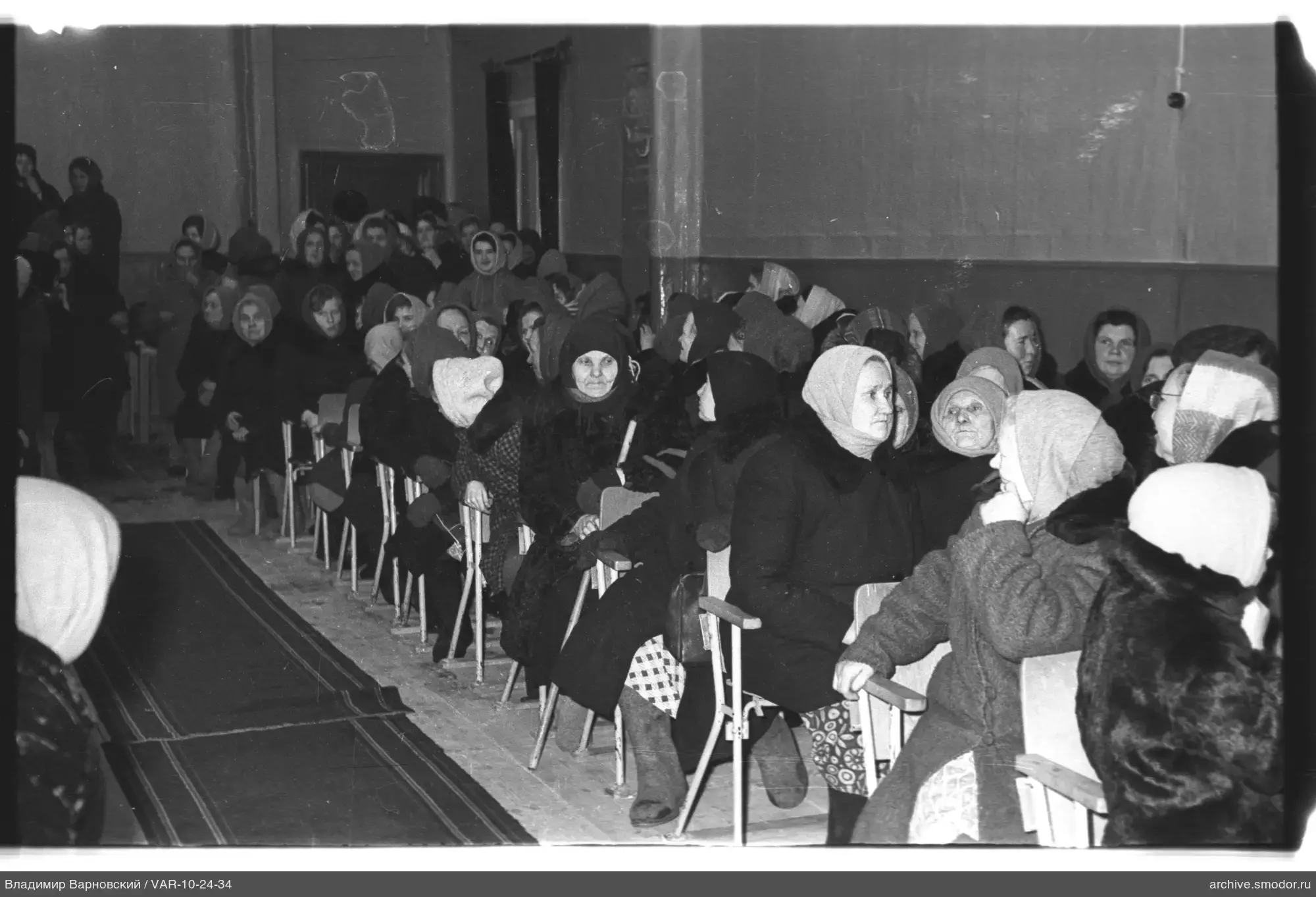 Women at an event in a room with wooden floor